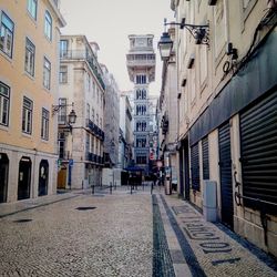 Street amidst buildings against sky in city