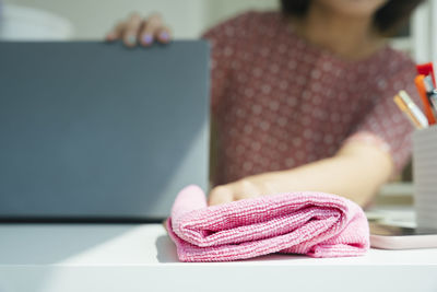 Close-up of woman reading book on table