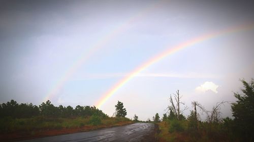 Scenic view of rainbow over landscape