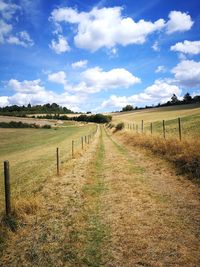 Scenic view of agricultural field against sky