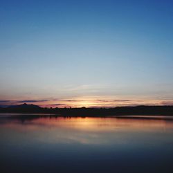 Scenic shot of calm lake at sunset
