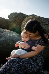 Vietnamese mother holding mixed race infant son