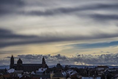 Buildings against cloudy sky