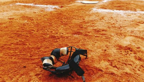 High angle view of baseball face mask on field