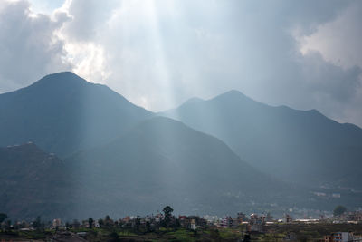 Panoramic view of buildings and mountains against sky