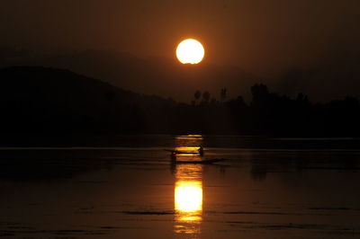 Scenic view of lake against sky during sunset