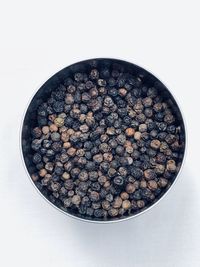 High angle view of fruits in bowl against white background