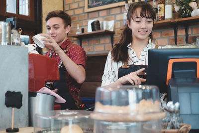 Baristas working in cafe