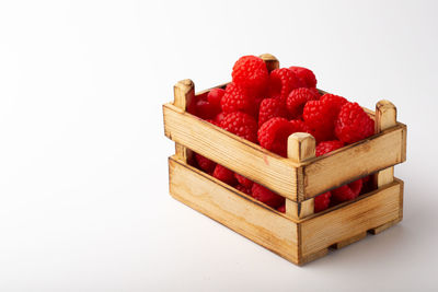 Close-up of strawberries in container against white background