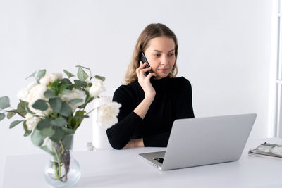 Young woman using laptop on table