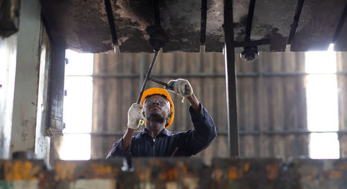 Man working in metal grate