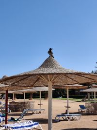 Built structure on beach against clear blue sky