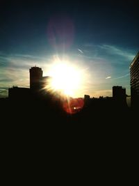 Silhouette buildings against sky during sunset