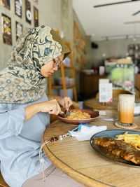 Midsection of woman having food