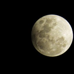 Low angle view of moon against clear sky at night