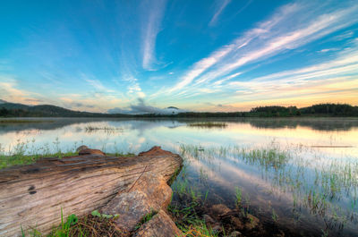 Scenic view of lake against sky during sunrise