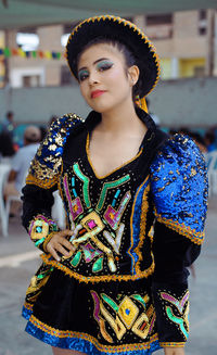 Portrait of young woman standing outdoors