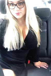 Beautiful young woman sitting in car