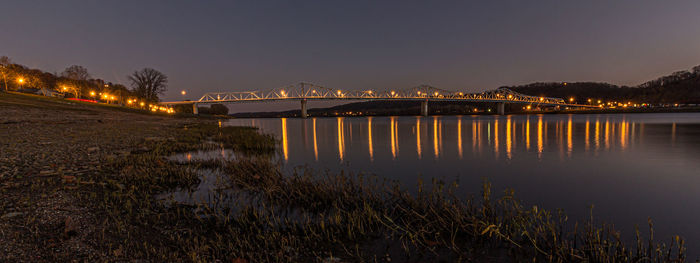  view of bridge across ohio river from madison indiana at night with light reflecting on the water
