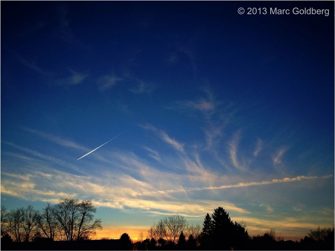 silhouette, tree, low angle view, sky, sunset, beauty in nature, tranquility, scenics, blue, cloud - sky, nature, tranquil scene, cloud, vapor trail, outdoors, no people, dusk, auto post production filter, bare tree, idyllic