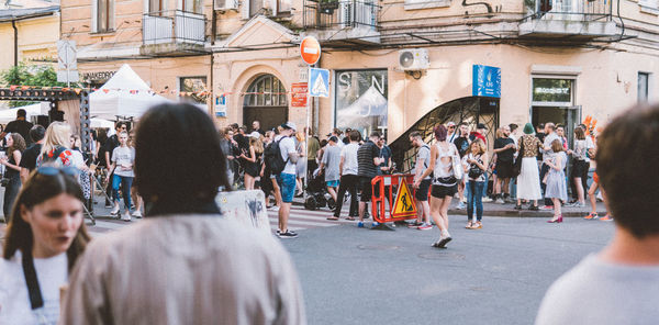 Group of people walking on street in city