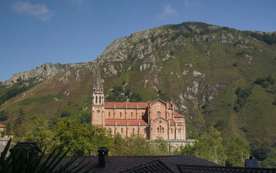 Exterior of building by mountains against sky