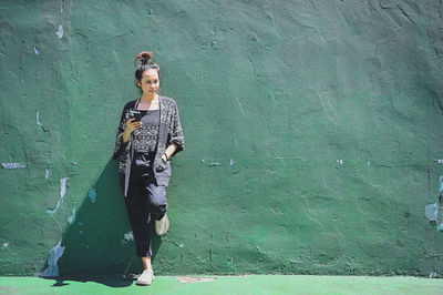 Series photo of happy young women in enjoying emotion with green background of real cement wall