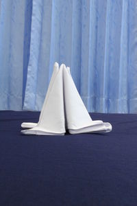 Close-up of white tent on bed