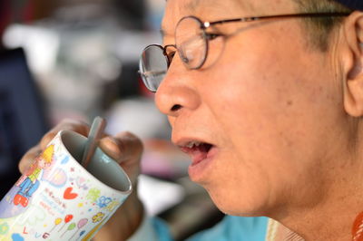 Close-up of man holding eyeglasses