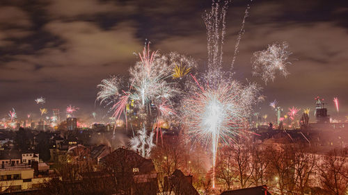 Firework display in city at night