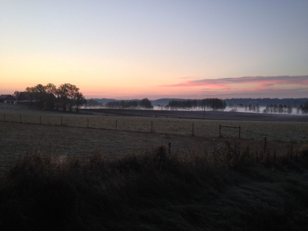 VIEW OF FIELDS AGAINST SKY AT SUNSET