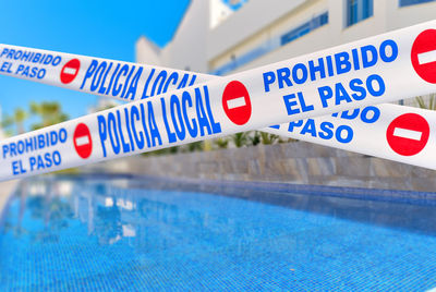 Close-up of warning sign on swimming pool