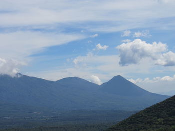 Scenic view of mountains against cloudy sky