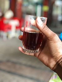 Close-up of hand holding wine glass