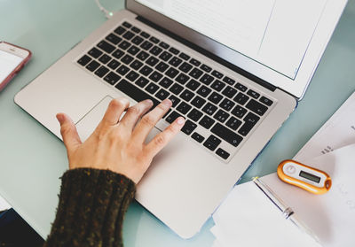 High angle view of person using laptop on table