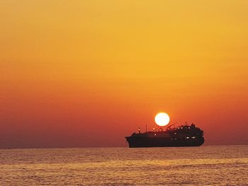 Scenic view of sea against orange sky