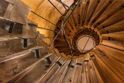 Directly below shot of wooden spiral staircase in building