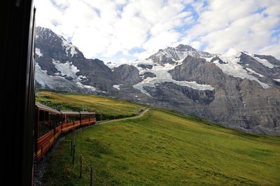 Train towards snowcapped mountain