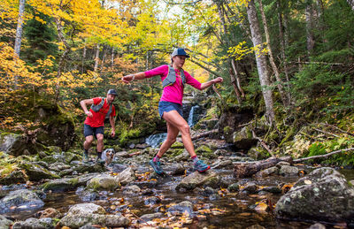 Woman standing on rock in forest