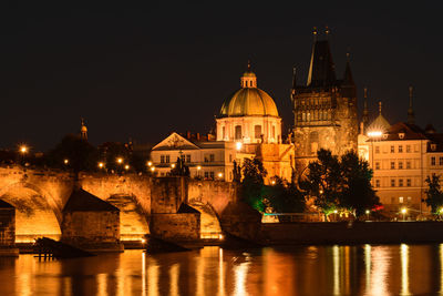 Illuminated buildings against sky at night