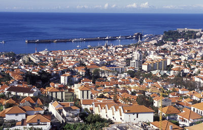 High angle view of cityscape against sea