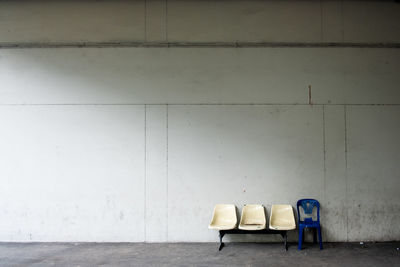 Empty chairs against wall