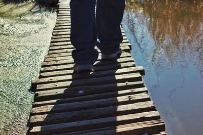 Low section of woman standing on cobblestone