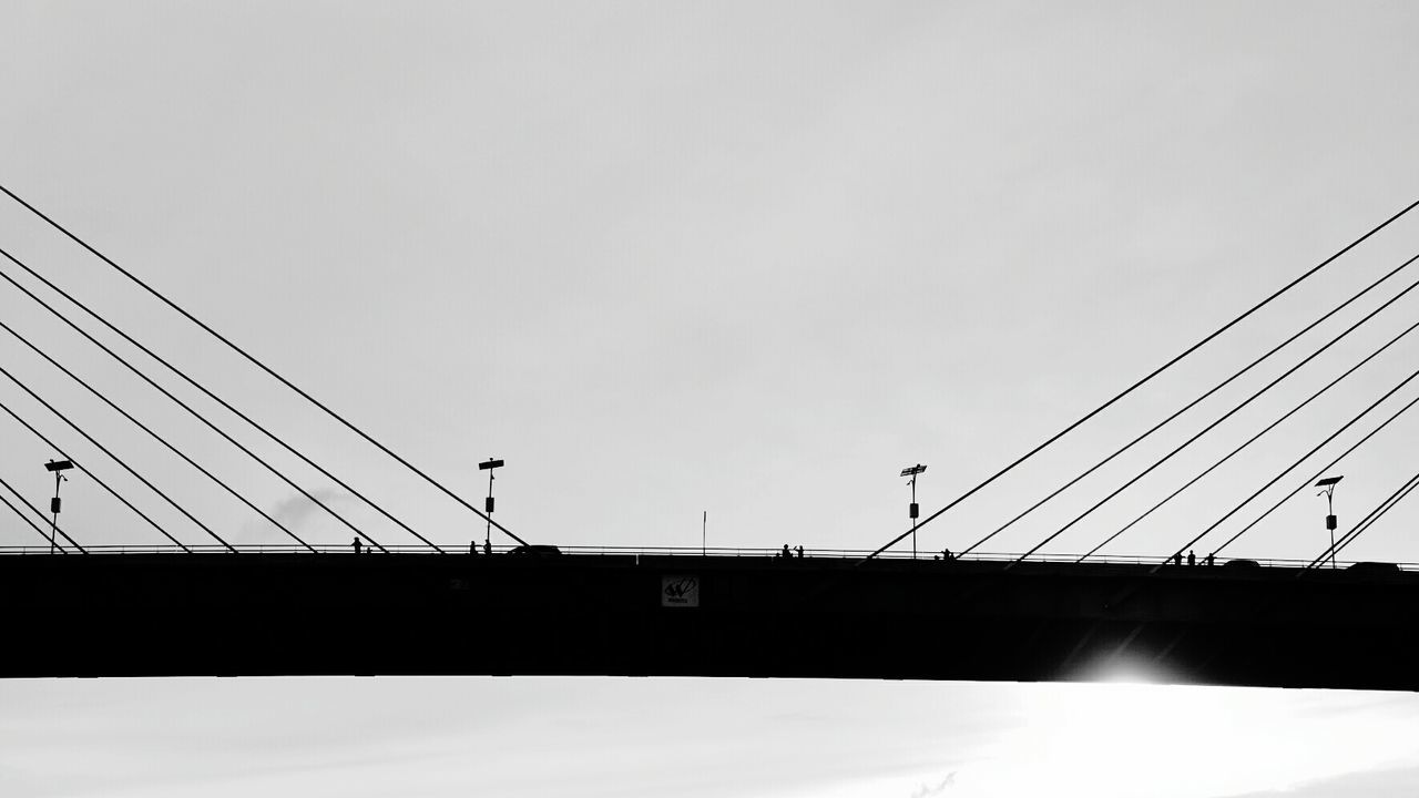 LOW ANGLE VIEW OF SUSPENSION BRIDGE AGAINST SKY