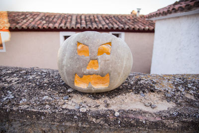 Close-up of pumpkin on stone wall during halloween