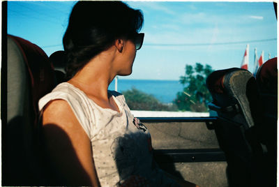 Close-up of man driving car against sky