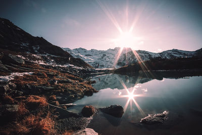 Scenic view of lake and mountains against sky