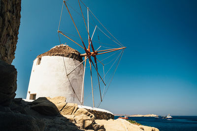 Scenic view of windmill against clear blue sky