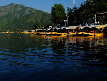 People enjoying in lake against sky