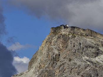 Low angle view of rock formations on mountain against sky